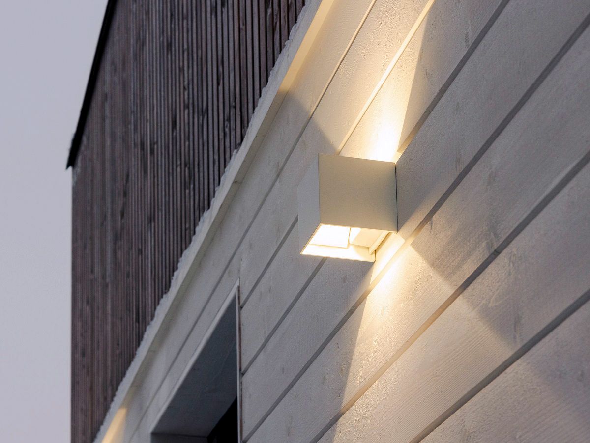 Primo piano di un'applique FUNK bianca su una parete esterna.